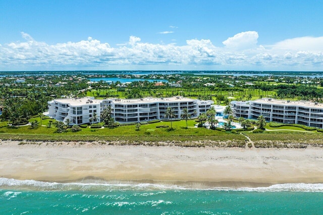 birds eye view of property with a beach view and a water view