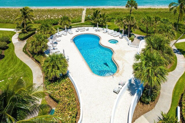 view of swimming pool with a water view and a patio area