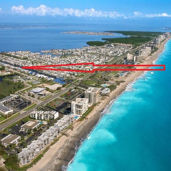 aerial view with a water view and a view of the beach