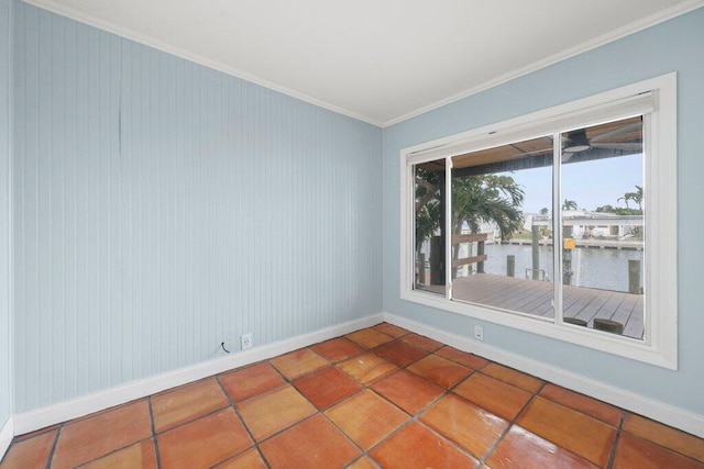 spare room featuring tile patterned flooring, ornamental molding, and a water view