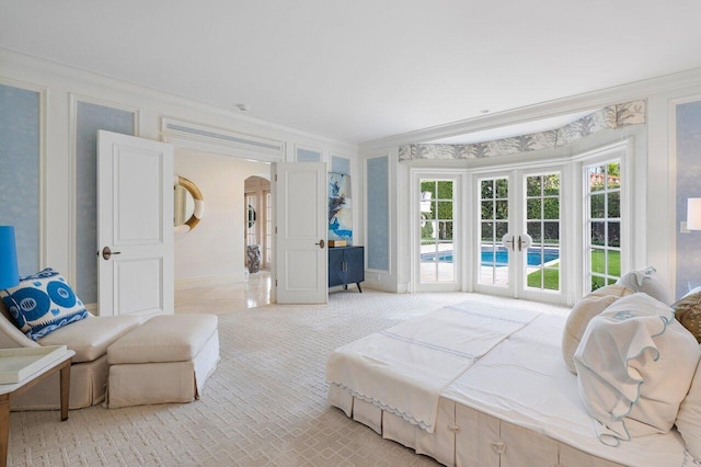 carpeted bedroom featuring french doors, crown molding, and access to exterior