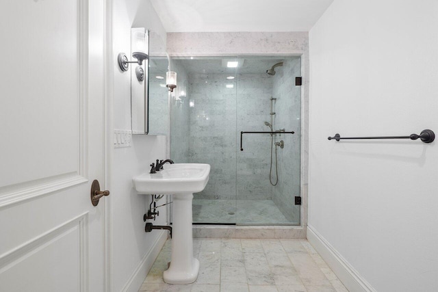 bathroom with a shower with shower door and tile floors