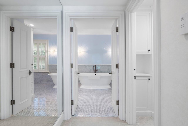 bathroom featuring tile floors and independent shower and bath