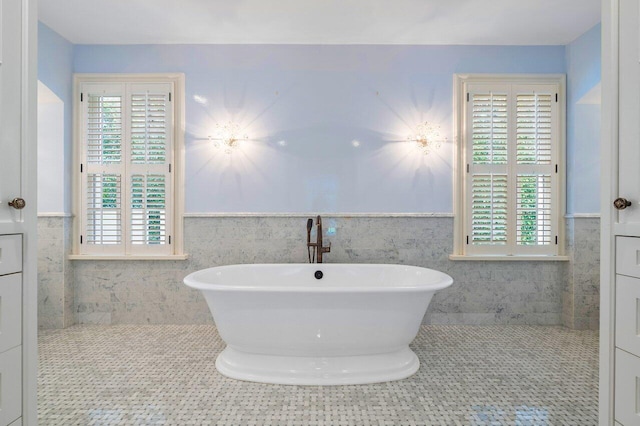 bathroom featuring tile walls, vanity, and a wealth of natural light