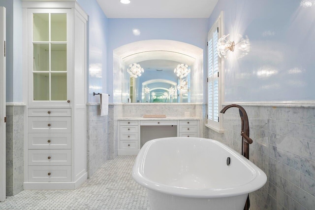 bathroom featuring a bathing tub, tile walls, vanity, and tile floors