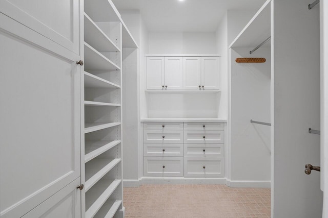 spacious closet featuring light tile floors