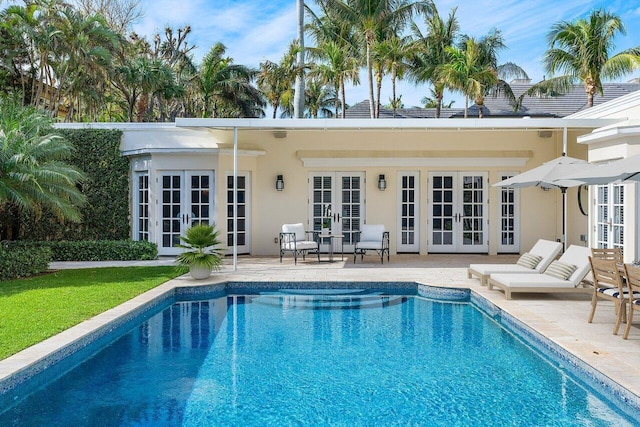 view of swimming pool featuring french doors and a patio