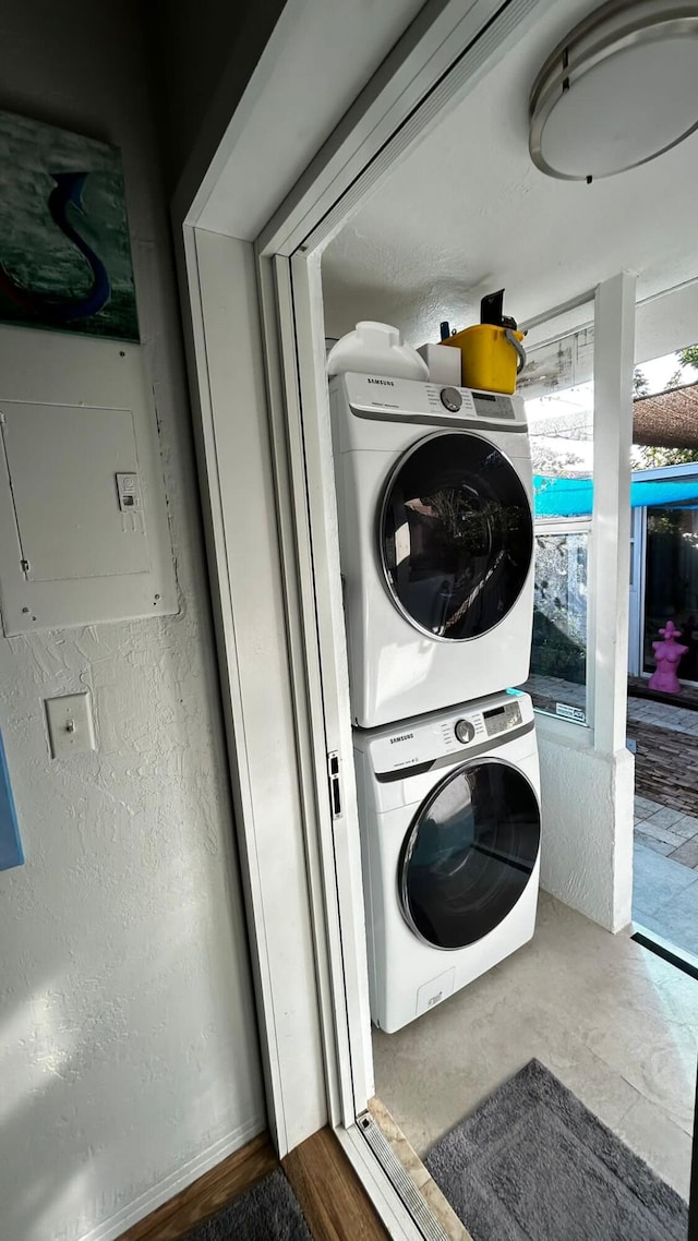 laundry area featuring stacked washer / drying machine