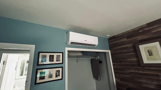 interior details with an AC wall unit and wooden walls