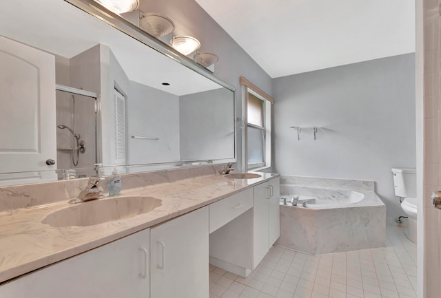 bathroom with dual sinks, tile flooring, toilet, a relaxing tiled bath, and oversized vanity