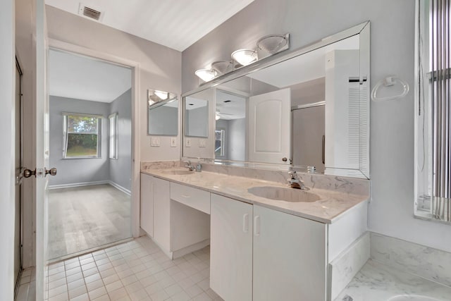 bathroom featuring dual bowl vanity and tile flooring