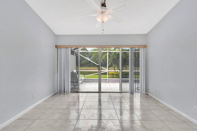 tiled empty room with ceiling fan