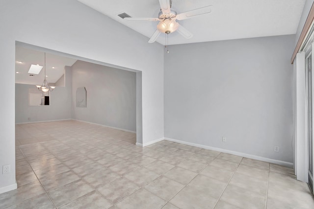 tiled empty room featuring ceiling fan with notable chandelier