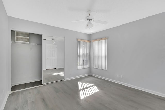 unfurnished bedroom featuring a closet, ceiling fan, and dark hardwood / wood-style floors