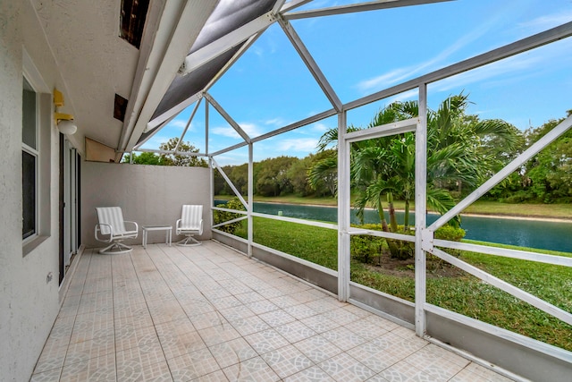 unfurnished sunroom featuring a water view