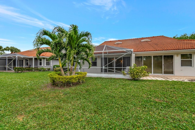 rear view of property featuring a yard and a lanai