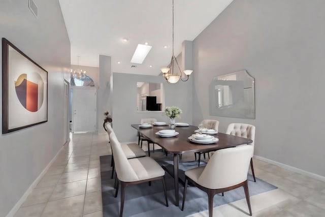 tiled dining area with a skylight and an inviting chandelier