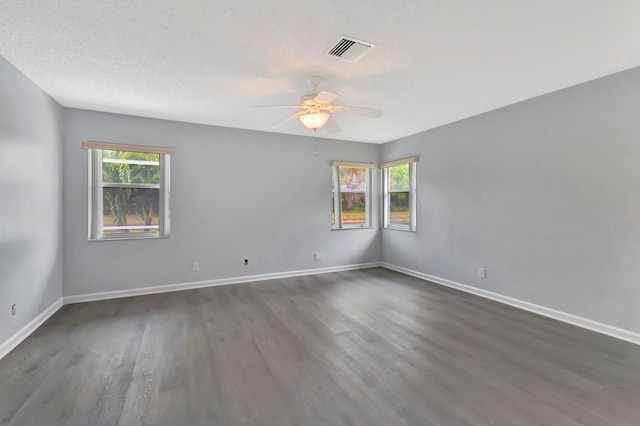 spare room featuring a textured ceiling, dark hardwood / wood-style floors, and ceiling fan