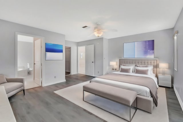 bedroom featuring dark hardwood / wood-style floors, ceiling fan, and ensuite bathroom