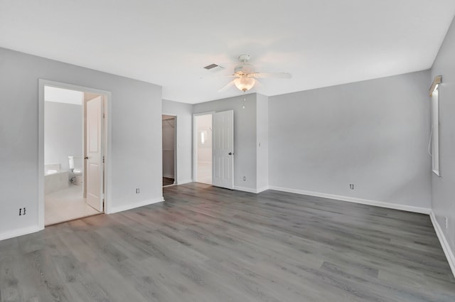 spare room featuring ceiling fan and dark hardwood / wood-style flooring