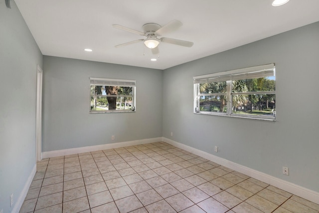 unfurnished room featuring light tile patterned flooring, plenty of natural light, and ceiling fan