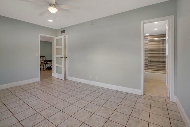 spare room with light tile patterned floors and ceiling fan