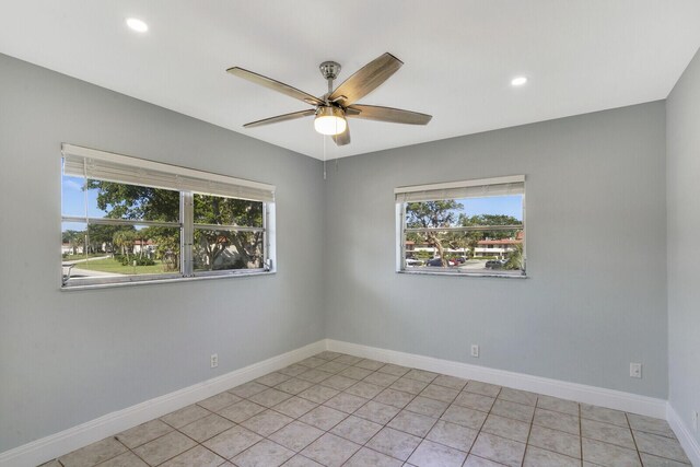 tiled spare room with ceiling fan