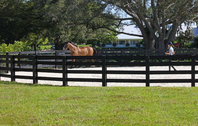 view of gate with a lawn