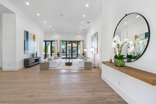 living room featuring french doors and light wood-type flooring