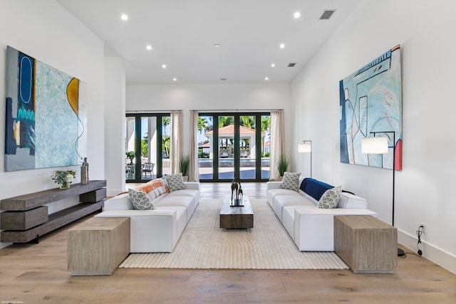 living room featuring light hardwood / wood-style floors and french doors