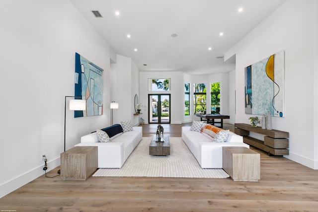 living room featuring french doors and light wood-type flooring