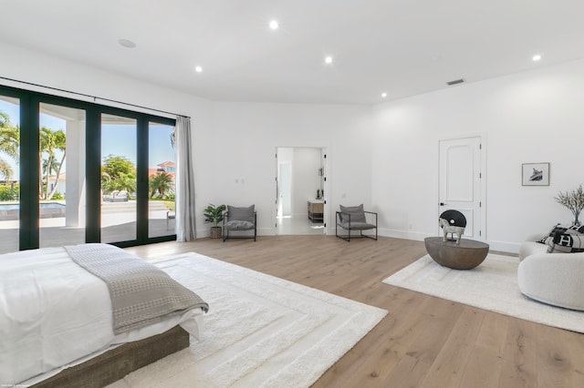 bedroom featuring french doors, access to exterior, and light hardwood / wood-style floors