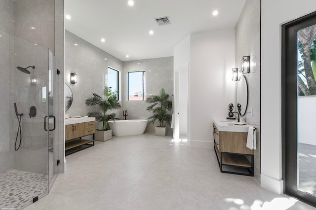 bathroom with a wealth of natural light, vanity, and plus walk in shower