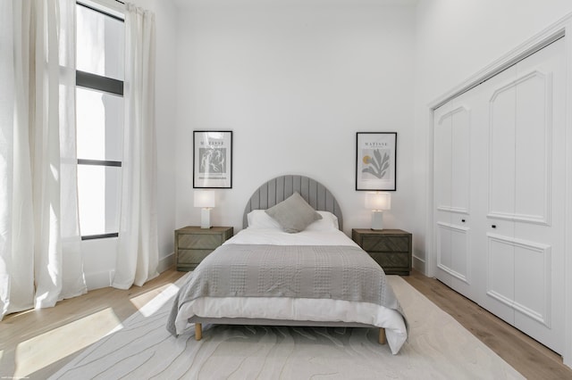 bedroom with a closet and light hardwood / wood-style floors