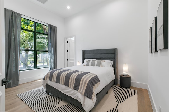 bedroom featuring light hardwood / wood-style floors and multiple windows