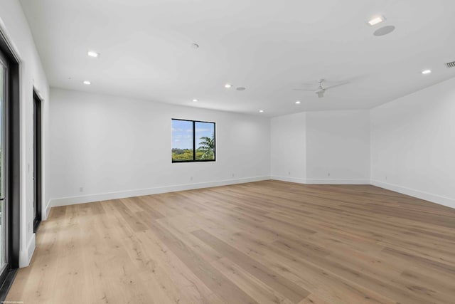 empty room with light wood-type flooring and ceiling fan