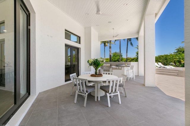 view of patio with area for grilling and ceiling fan