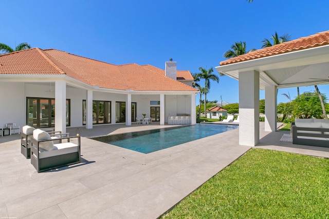 view of swimming pool featuring a yard, a patio area, ceiling fan, and outdoor lounge area