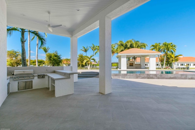 view of patio with area for grilling, grilling area, and ceiling fan