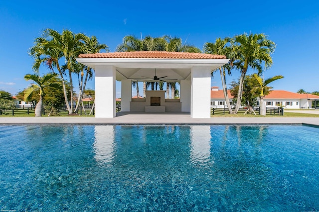 view of swimming pool featuring a patio area and ceiling fan