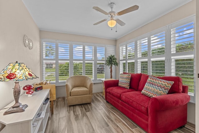 sunroom / solarium featuring ceiling fan