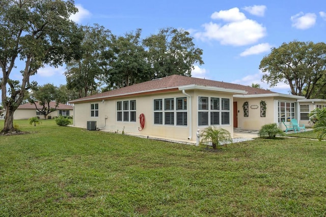 back of house featuring a patio, cooling unit, a lawn, and stucco siding