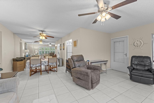 living room featuring light tile patterned floors and a textured ceiling