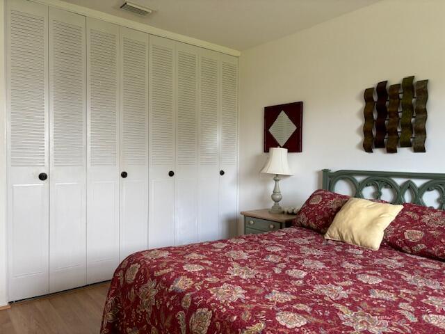 bedroom featuring hardwood / wood-style floors and a closet