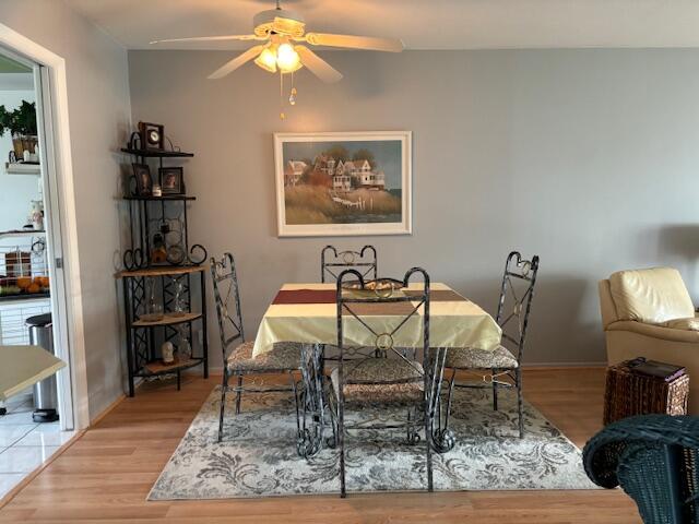 dining space featuring ceiling fan and light hardwood / wood-style flooring