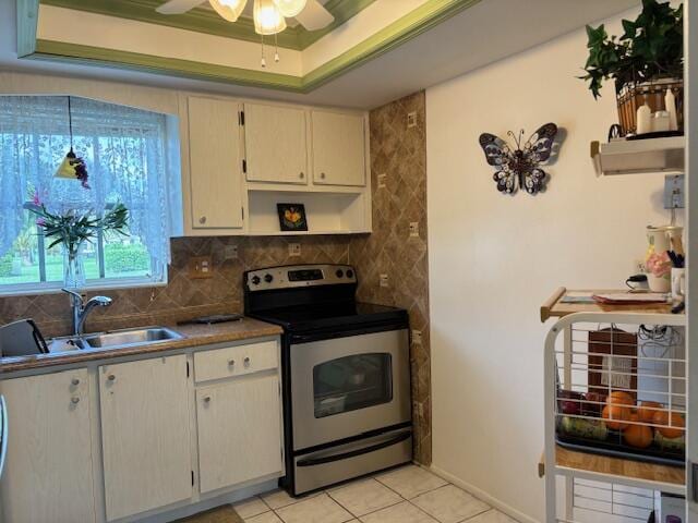 kitchen with stainless steel range with electric cooktop, sink, backsplash, a raised ceiling, and light tile patterned floors