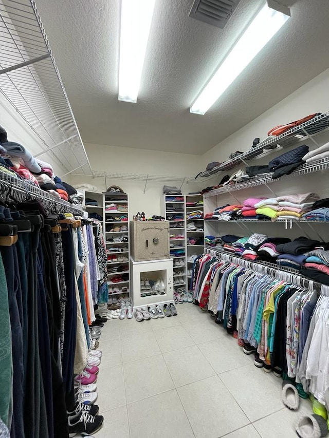 spacious closet featuring light tile floors