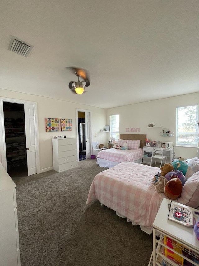 carpeted bedroom with multiple windows