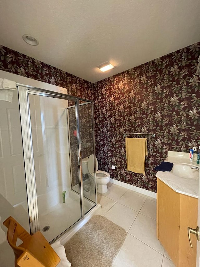 bathroom featuring toilet, tile floors, an enclosed shower, and vanity