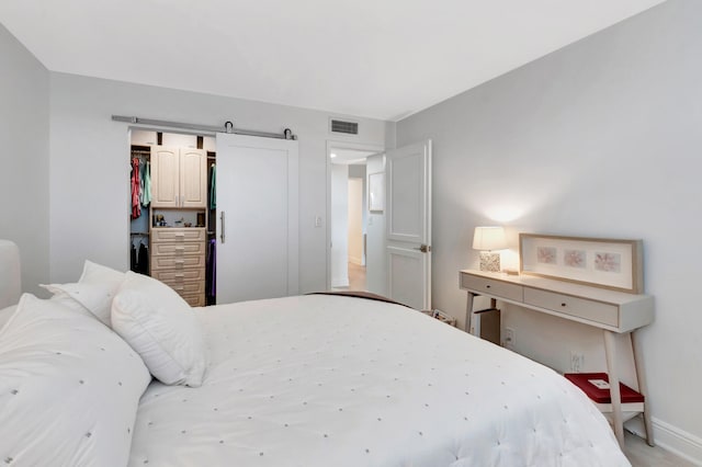 bedroom with a closet and a barn door